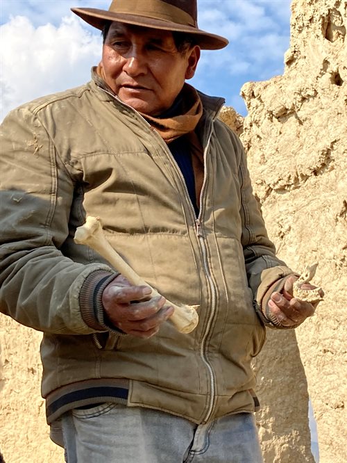 A community leader of Culli Culli shows researchers how easily human remains may be found within a cultural preservation center encompassing a 1,000-year-old burial ground for wealthy Aymara ancestors